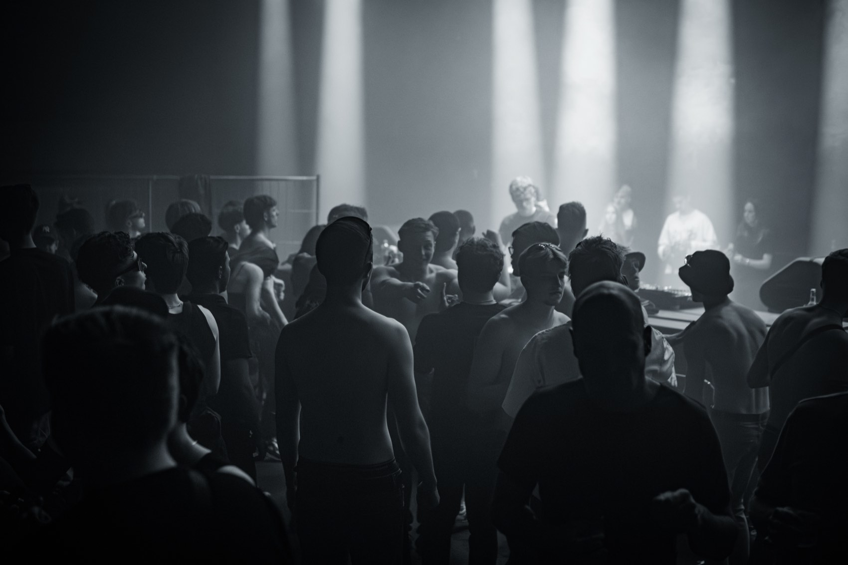 Black and white crowd under falling white beams