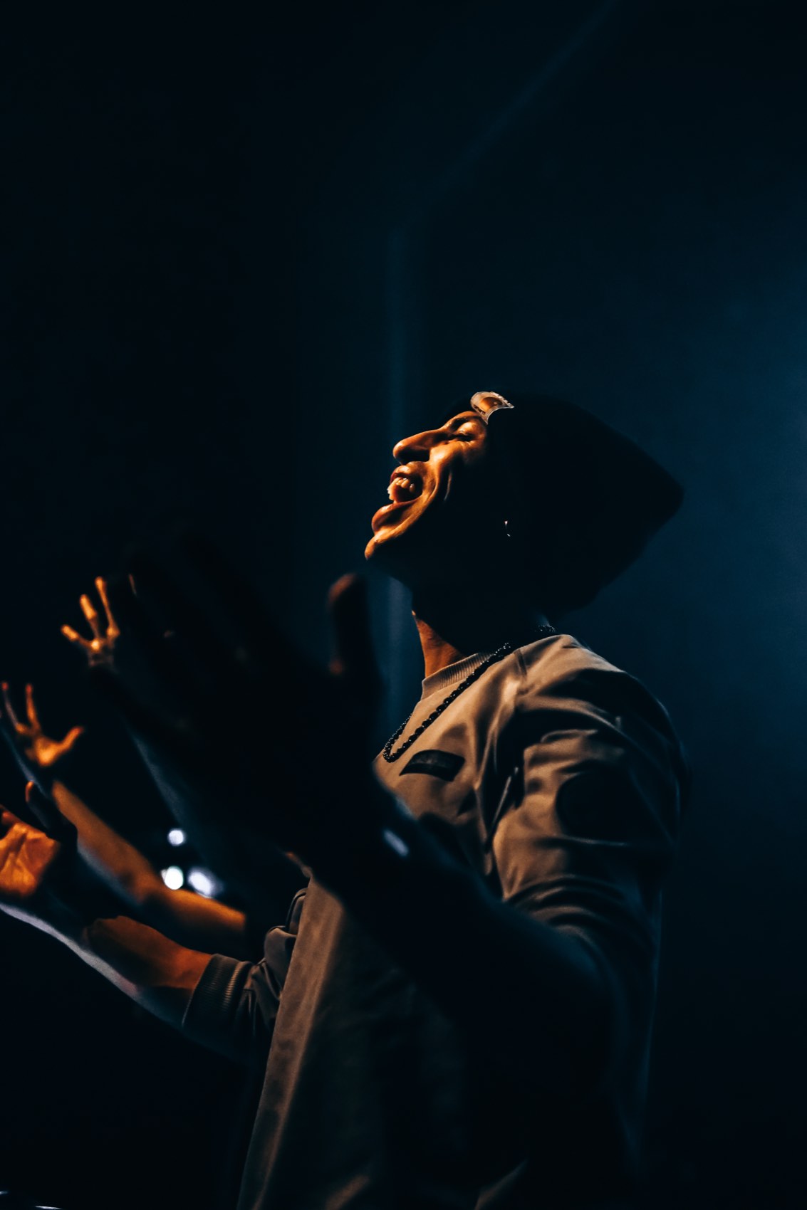 Backlit artist in a bucket hat, gold rim light
